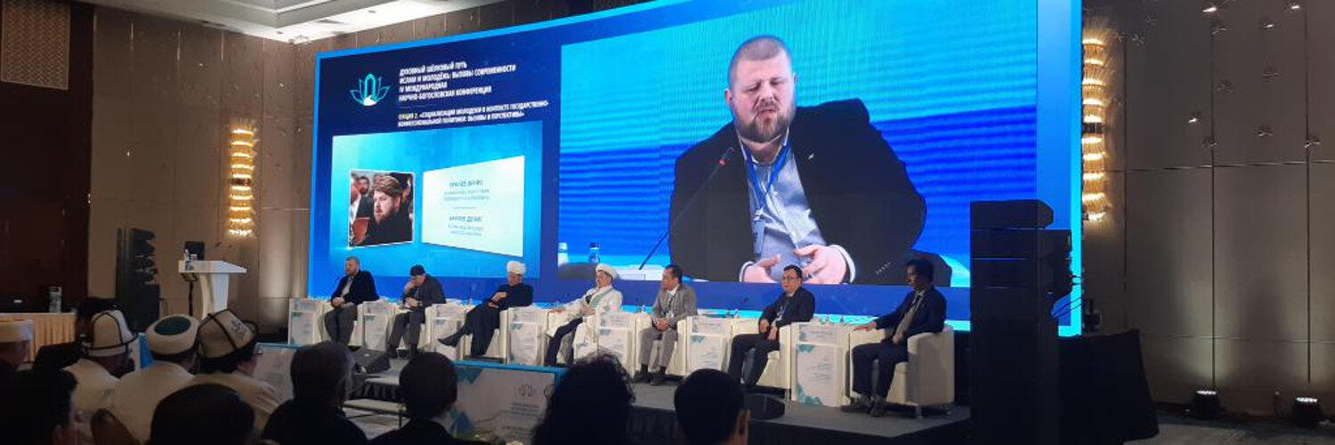 Denys Brylov speaking at an international conference in Kazakhstan